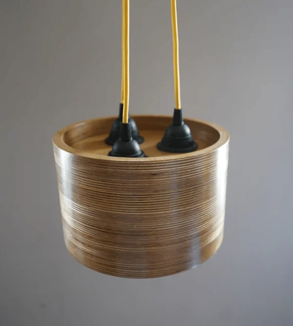 Triple Bulb Round Pendant Light made of layered birch plywood with a smooth finish, suspended by a yellow fabric cable.