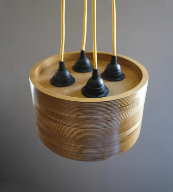 Quad Bulb Round Pendant Light made of layered birch plywood with a smooth finish, suspended by a yellow fabric cable.