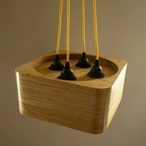 4 Bulb Square Pendant Light made of layered birch plywood with a smooth finish, suspended by a yellow fabric cable.