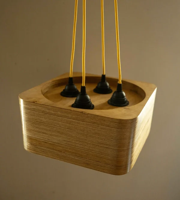 4 Bulb Square Pendant Light made of layered birch plywood with a smooth finish, suspended by a yellow fabric cable.
