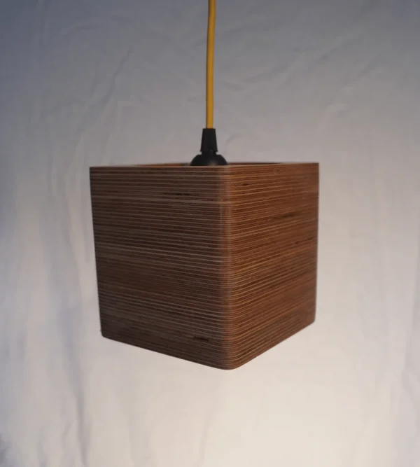Modern Single Bulb Square Pendant Light with exposed plywood look & hanging from yellow fabric cable