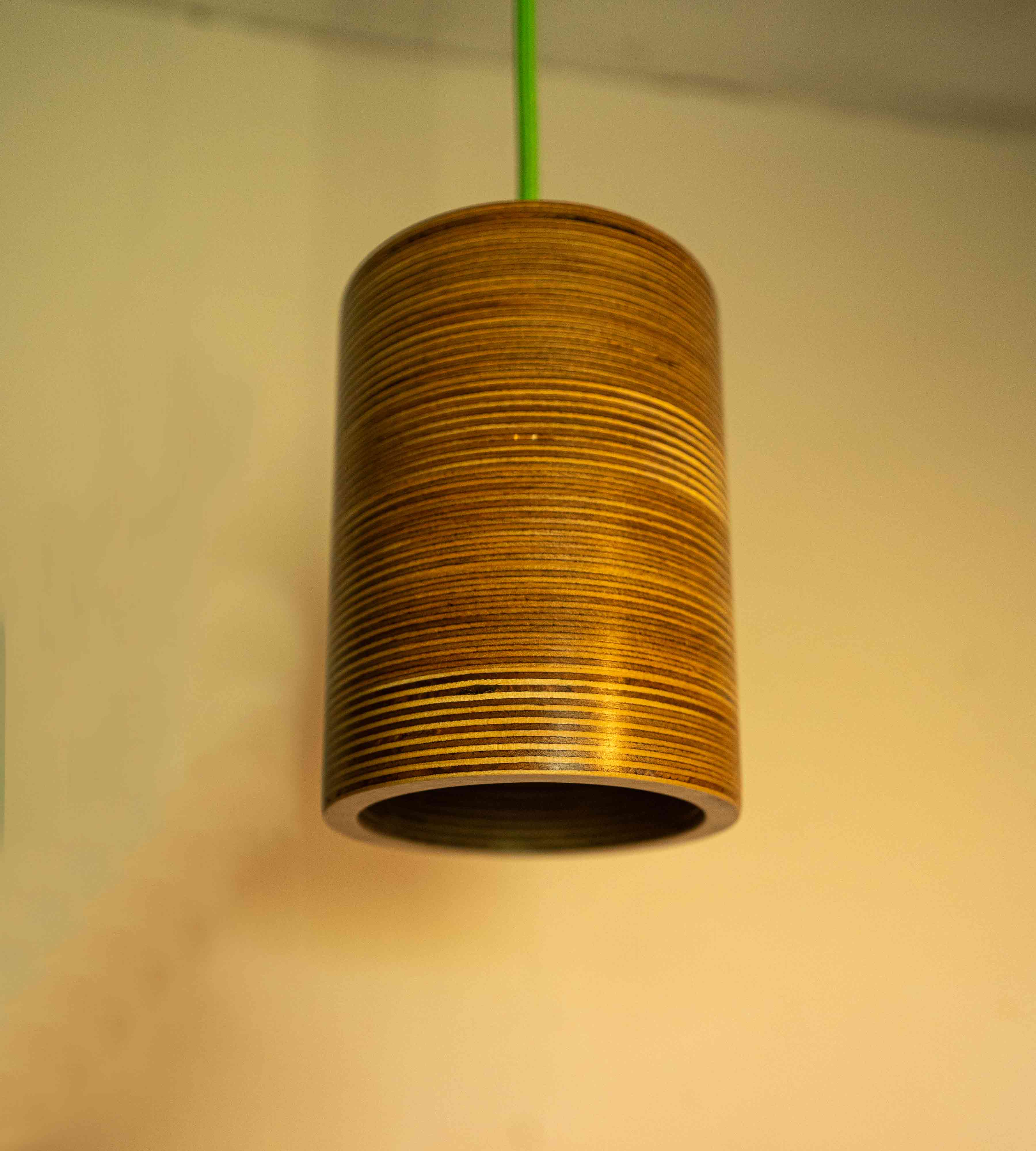 The elegance modern Single Bulb Round Pendant Light with exposed plywood look & hanging from green fabric cable