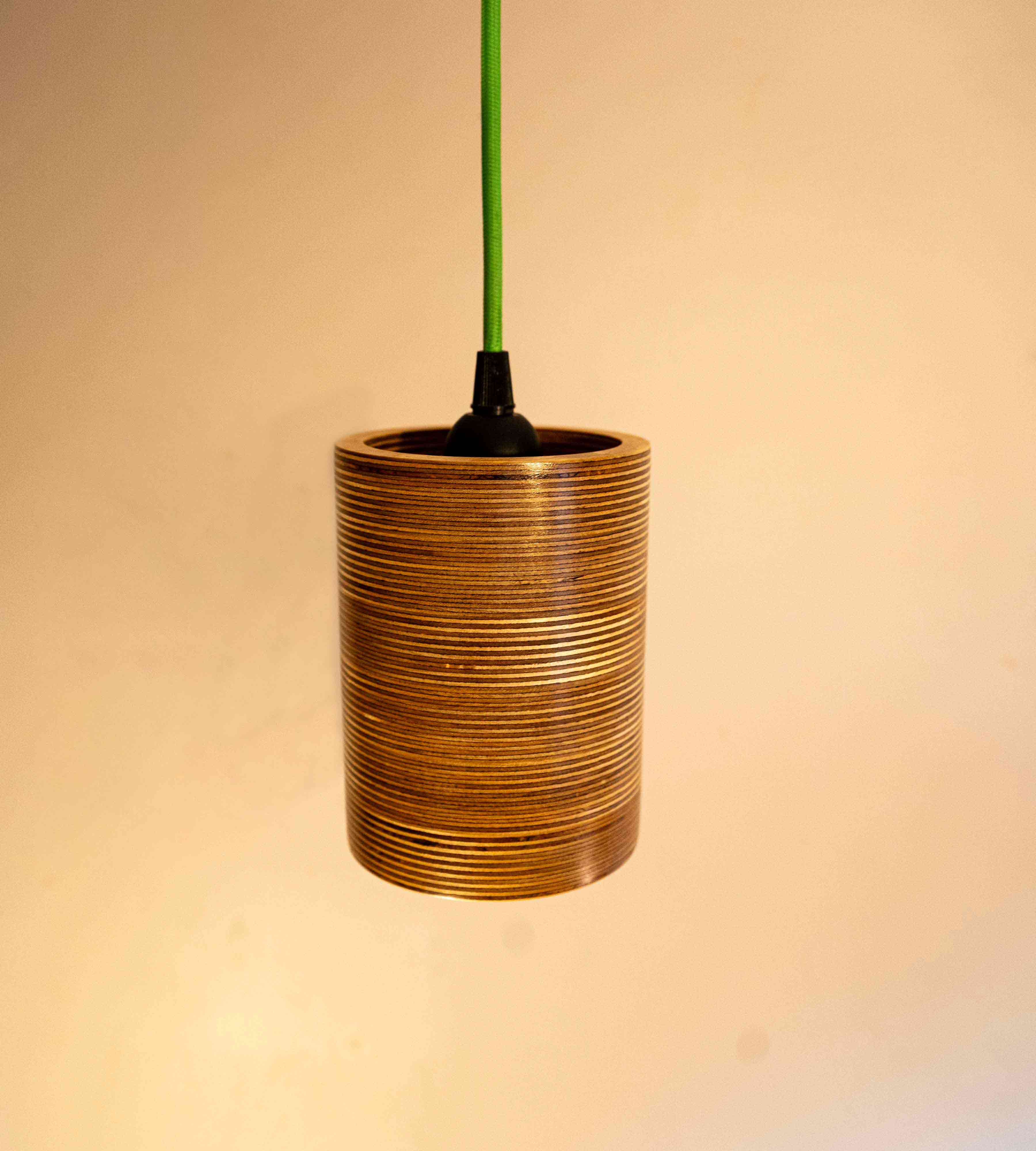 Single Bulb Round Pendant Light made of layered birch plywood with a smooth finish, suspended by a yellow fabric cable.