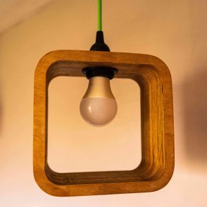Single Bulb Halo Pendant Light made of layered birch plywood with a smooth finish, suspended by a yellow fabric cable.